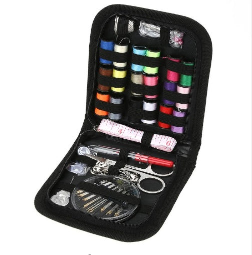 Sewing kit with colorful thread spools, scissors, and other tools in a black case.