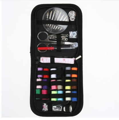 Sewing kit with various tools and threads in a black case on a white background